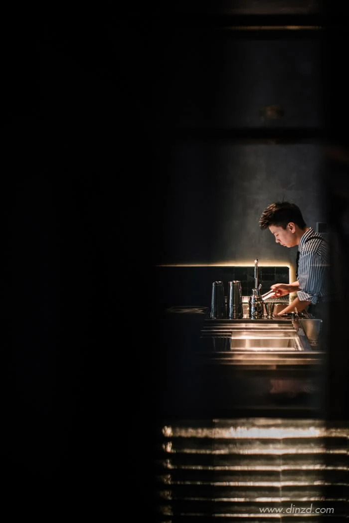 Bartender working in dramatic low light