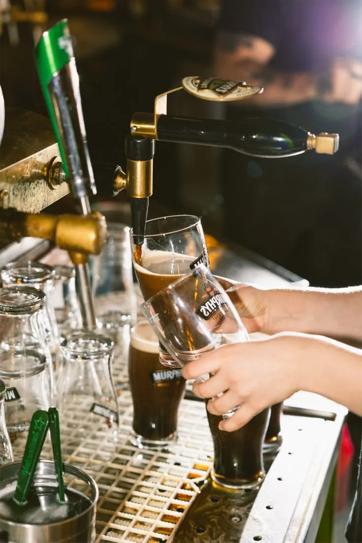 Busy bar service with pints being poured