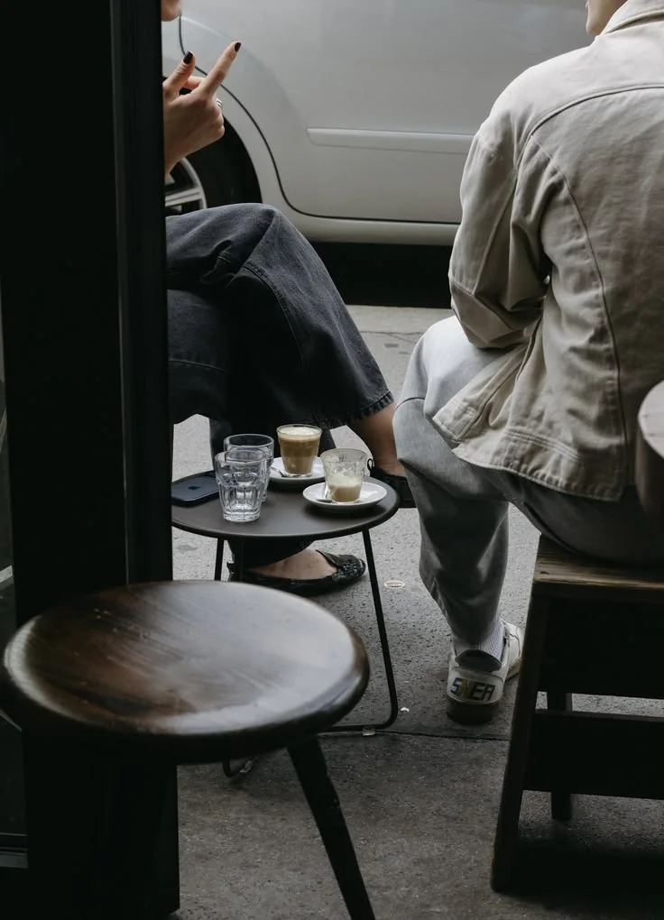 Customers sharing coffee outside a café