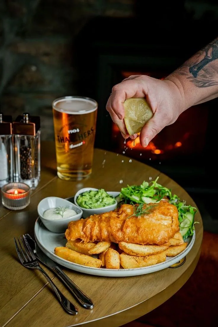 Fresh fish and chips with beer in a casual hospitality setting