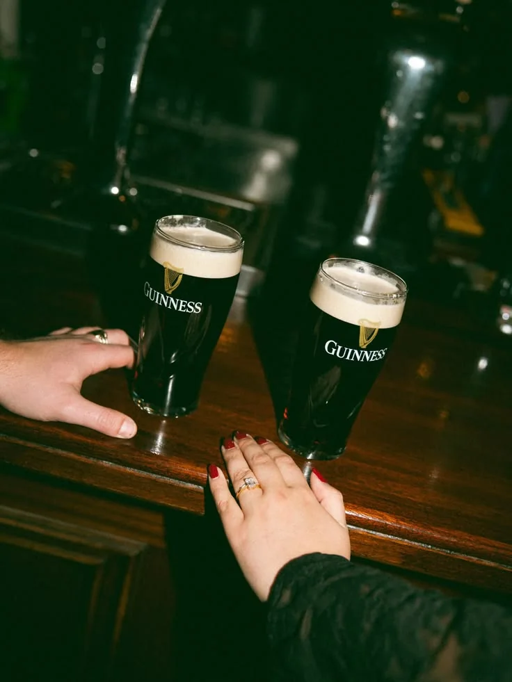 Two pints of Guinness in a traditional Irish pub