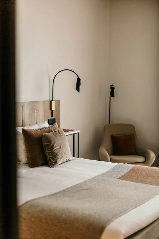 Minimal contemporary hotel bedroom in soft natural light