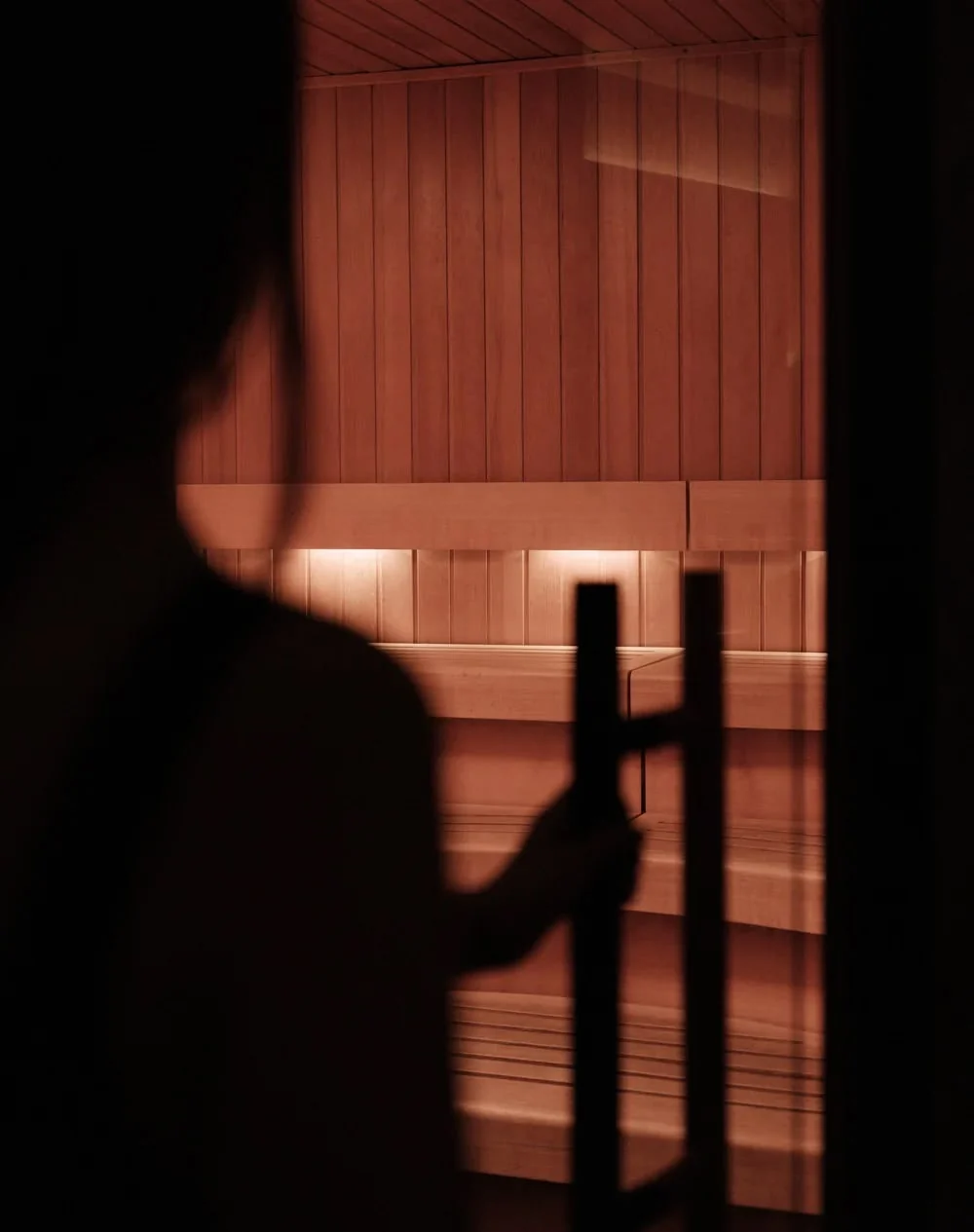 Atmospheric timber sauna interior in warm low light