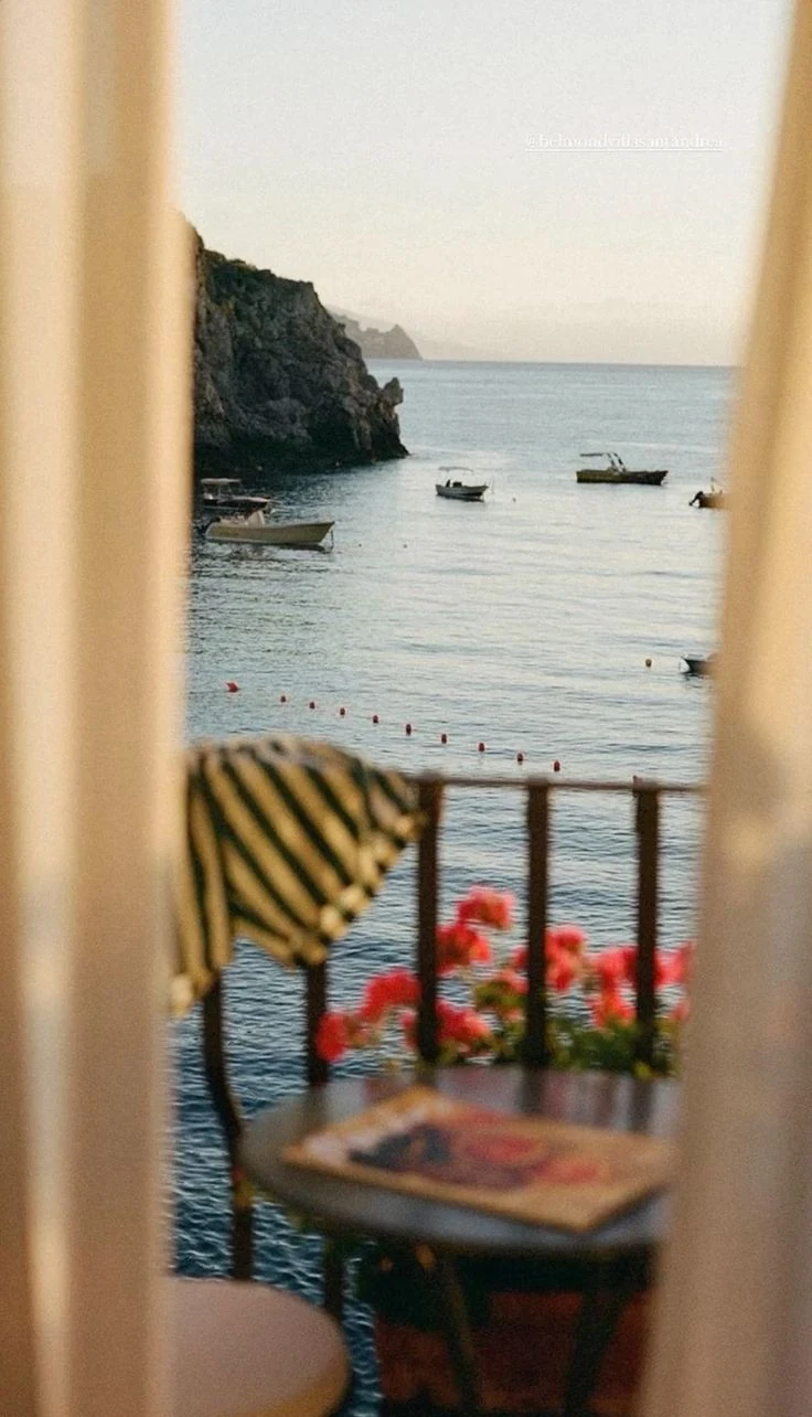 Sea view framed by curtains from a hotel terrace on Isola di San Pietro in Sardinia