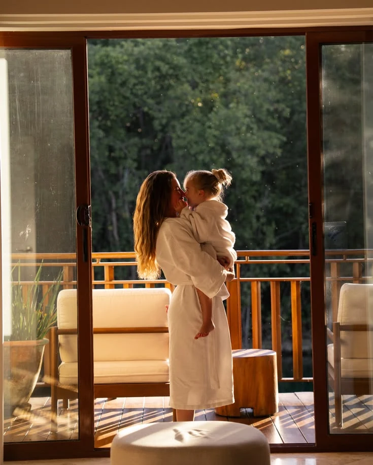 Mother and child in hotel robes in warm morning light on Isola di San Pietro in Sardinia