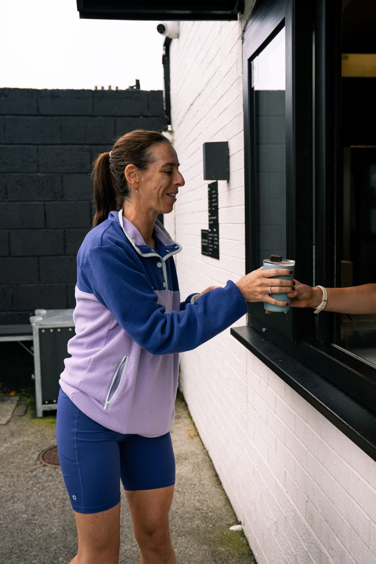 Customer receiving a takeaway coffee at the Jimmys drive thru window