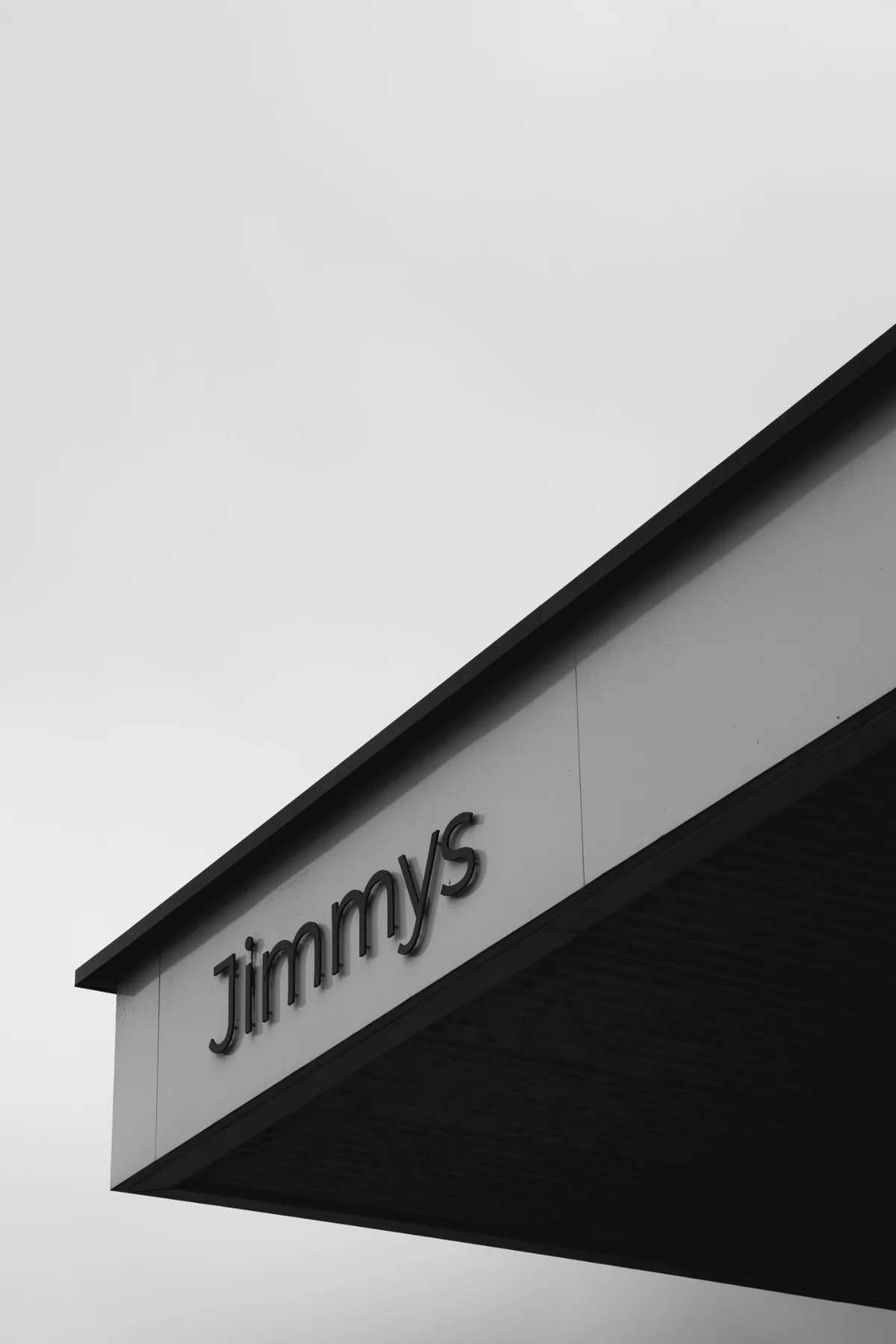Black and white architectural detail of the Jimmys exterior sign