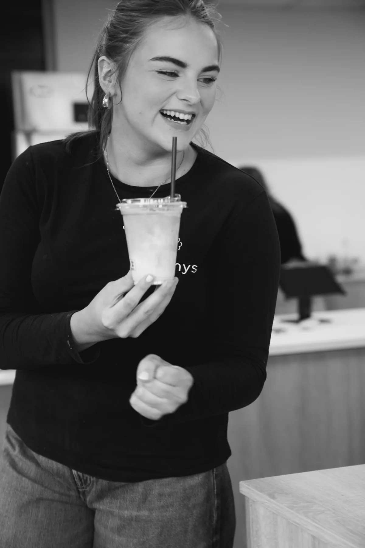 Black and white portrait of a Jimmys team member with a cold drink