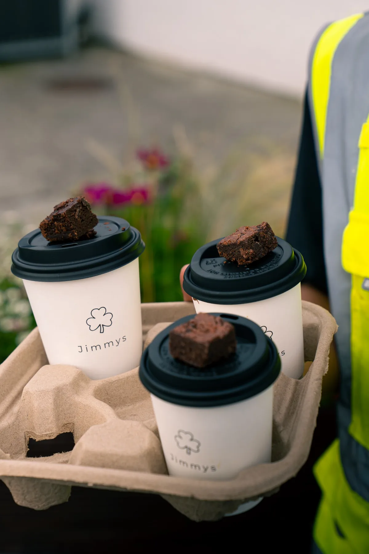 Tray of branded Jimmys takeaway coffees with brownies