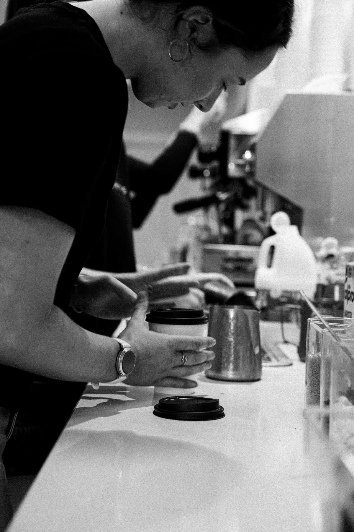 Black and white documentary photograph of coffee preparation at Jimmys
