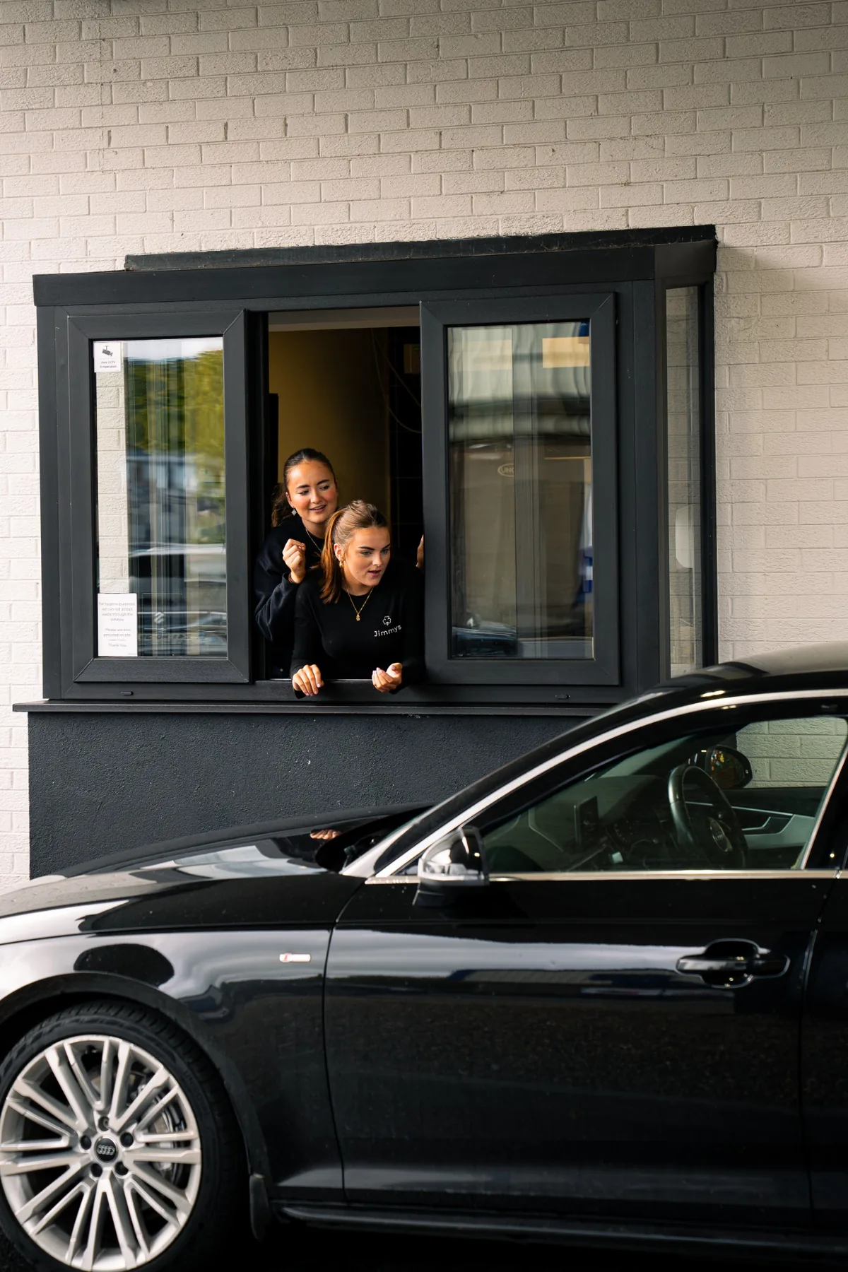 Jimmys team at the drive thru window with a customer car