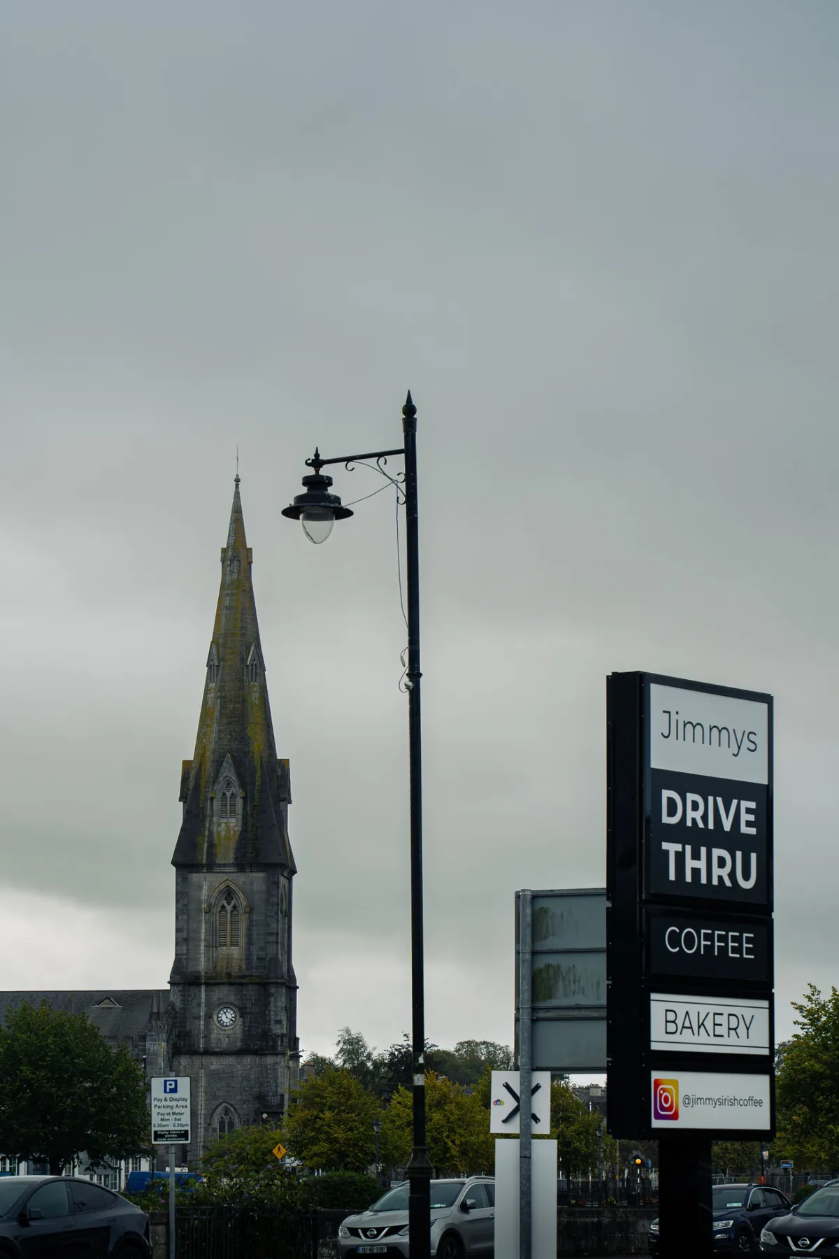 Jimmys Drive Thru roadside sign with Ballina church in the background