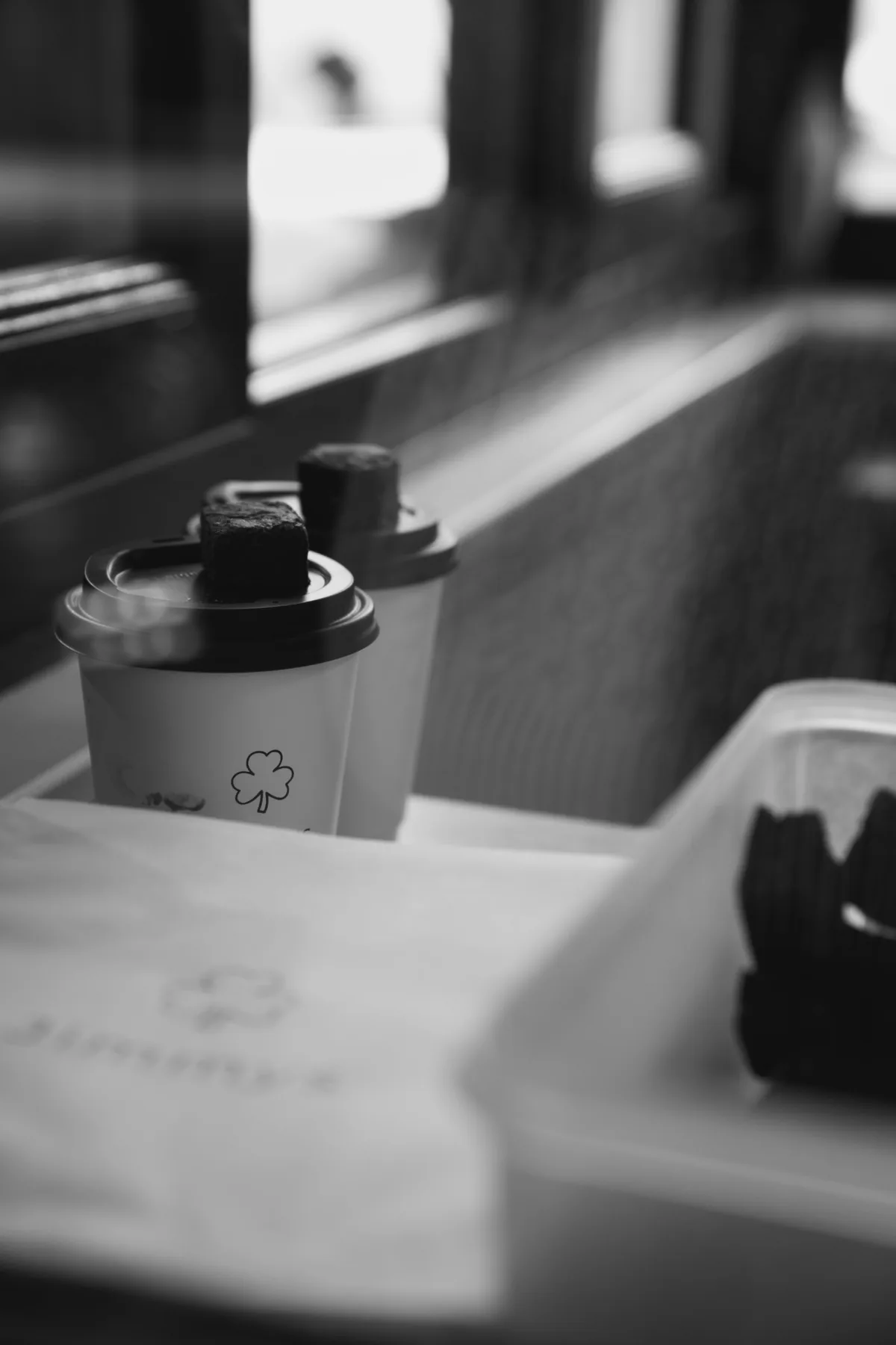 Black and white takeaway coffee cups at the Jimmys drive thru window