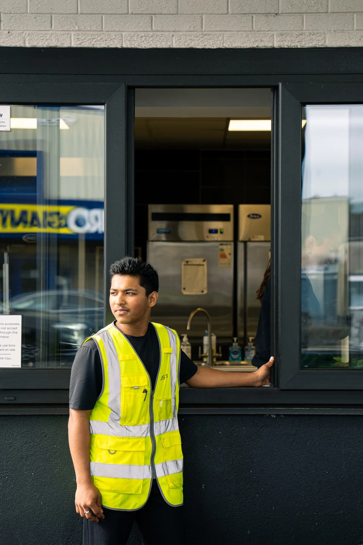 Portrait of a Jimmys staff member at the drive thru service window