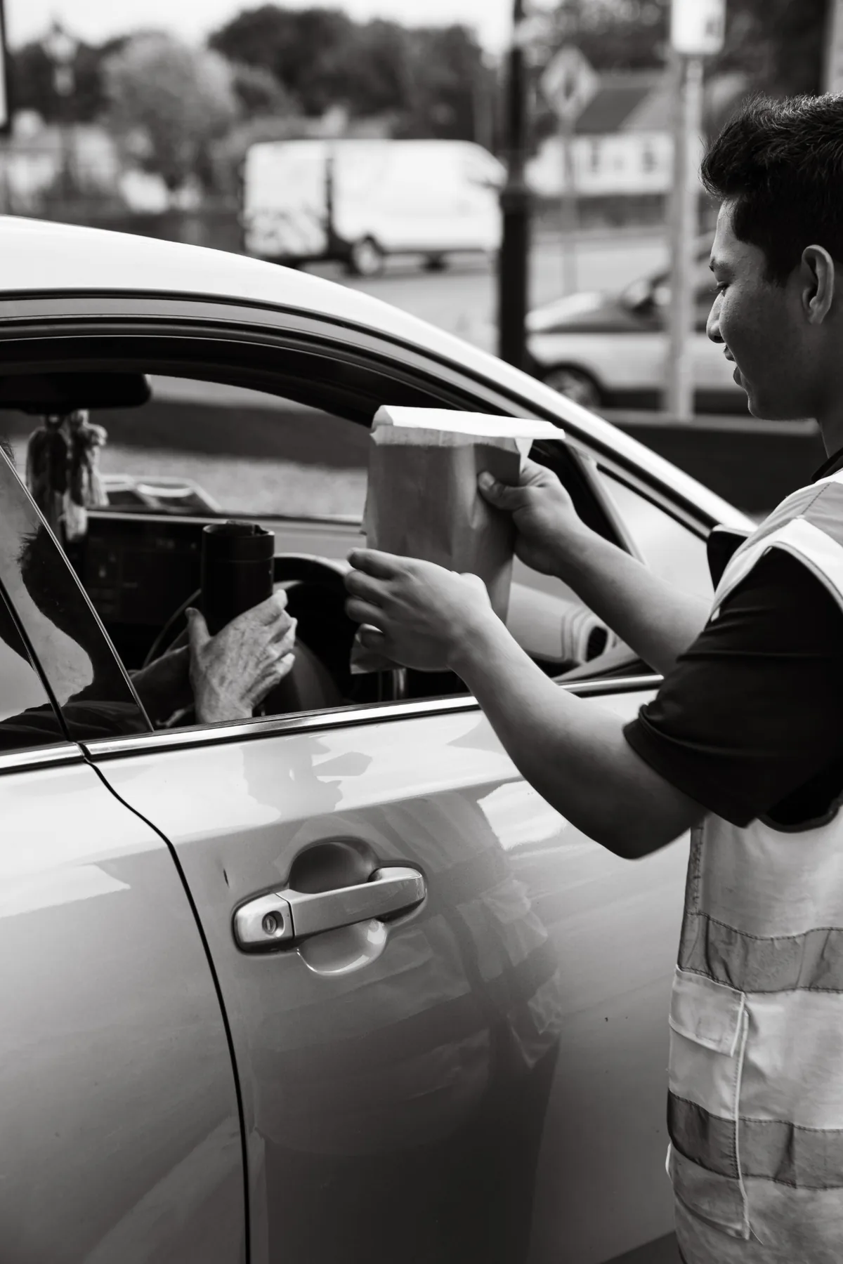 Black and white customer handoff at Jimmys Drive Thru in Ballina