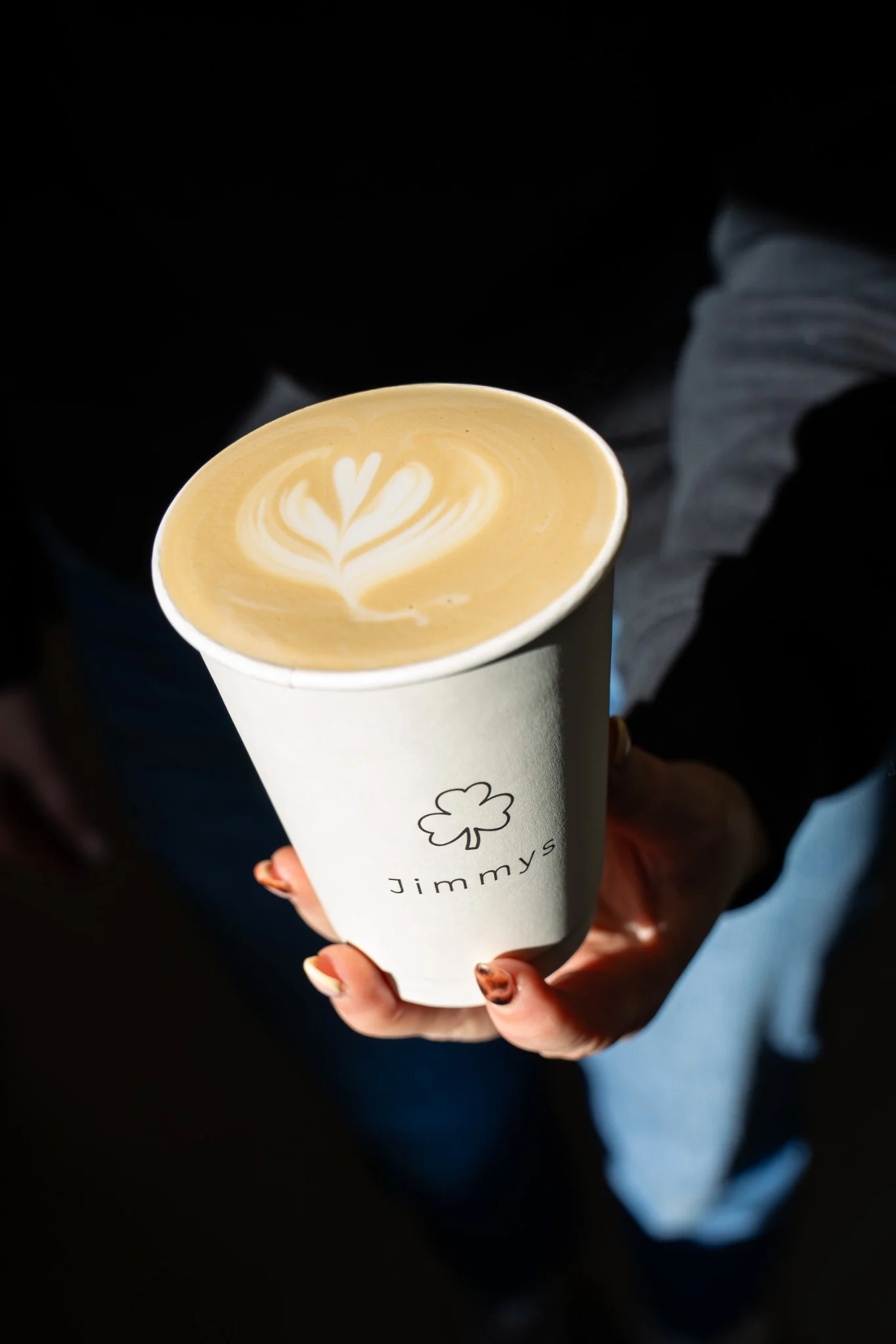 Latte art in a branded Jimmy’s takeaway cup