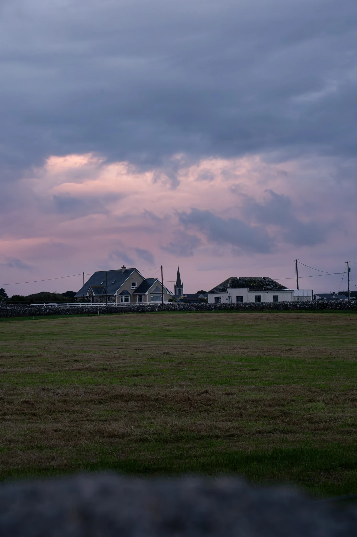 Easkey countryside and village skyline beneath a soft pink evening sky