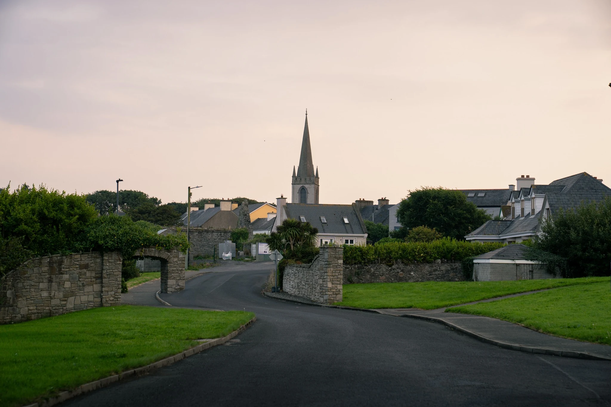 Village houses and church spire in rural Ireland at dusk