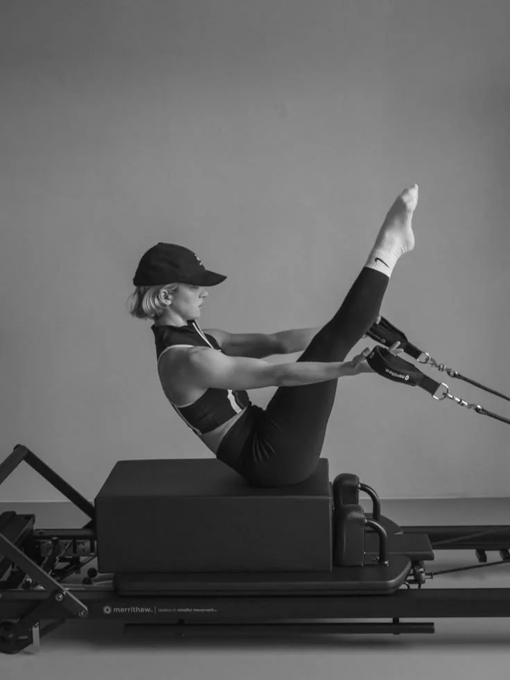 Pilates movement on a reformer in monochrome