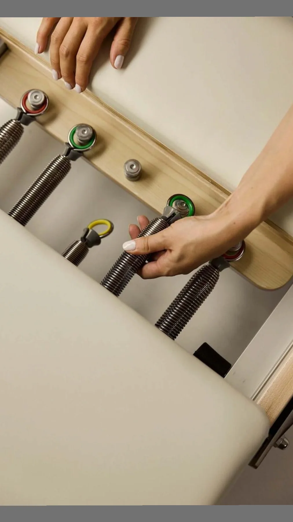 Pilates reformer spring system photographed from above