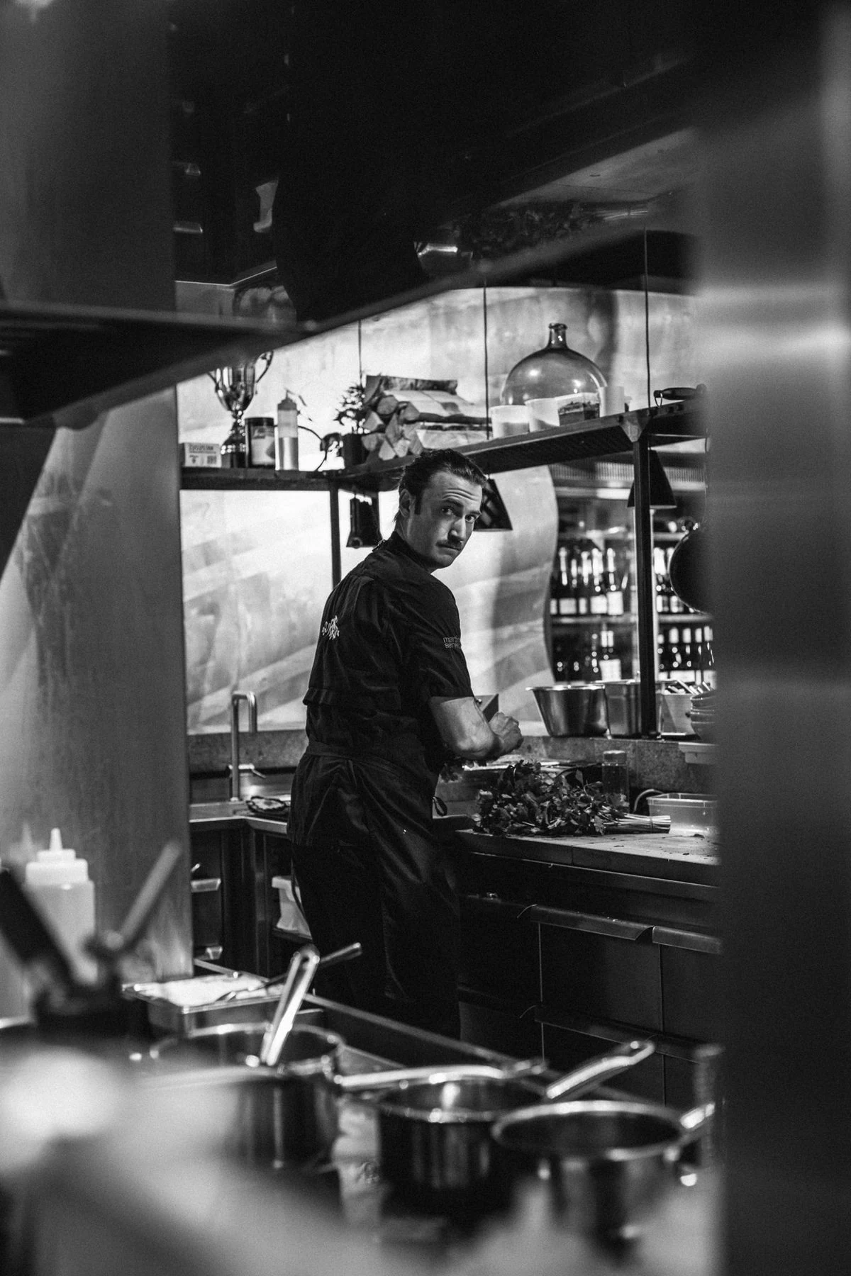 Chef at work in a restaurant kitchen in black and white